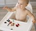 high angle cute baby highchair choosing what fruit eat