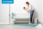 AeroSleep babyroom AM EV 120 060 fitted sheet with model holding baby
